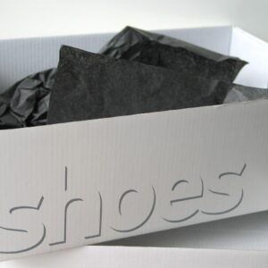 Black tissue paper inside a white shoe box
