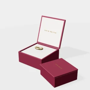 3D render of a small burgundy magnetic jewelry box with a gold foil logo